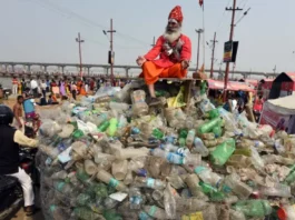 A sadhu sitting on a pile of garbage in Kumbh Mela